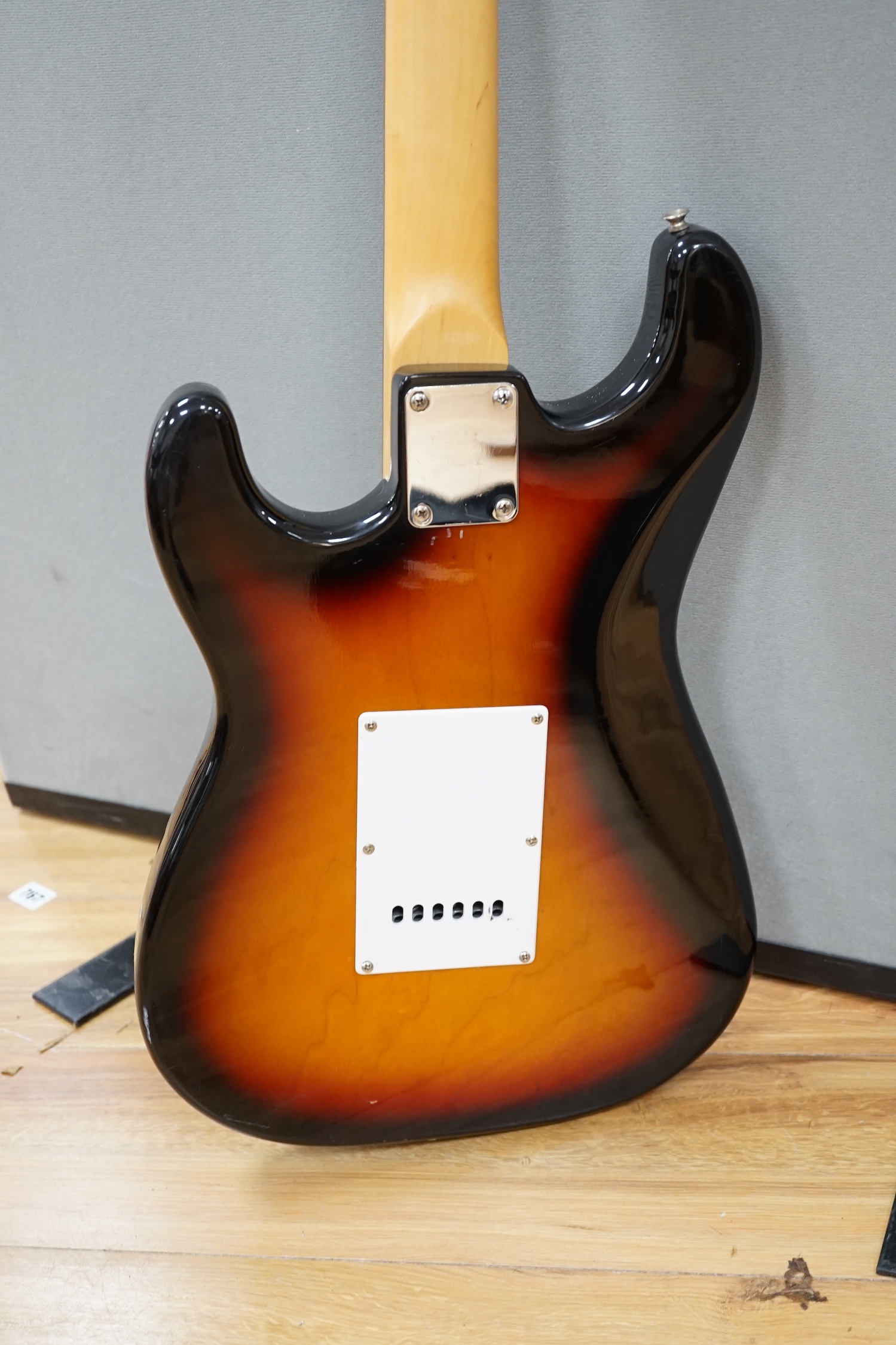 A Collins Sunburst electric guitar with hard flight case